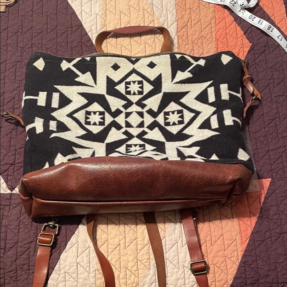 Meant manufacturing Pendleton wool and leather backpack purse.